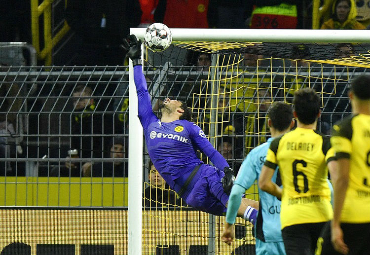 Dortmund goalkeeper Roman Buerki jumps for the ball that hits the bar during the Bundesliga game against SC Freiburg