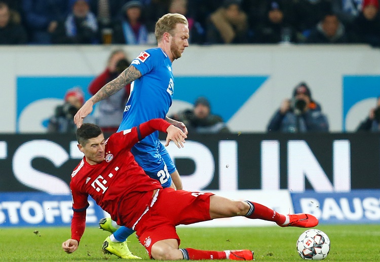 Bayern Munich's Robert Lewandowski fights for the ball with Hoffenheim's Kevin Vogt