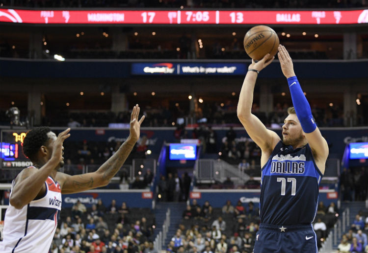 NBA: Dallas Mavericks' Luka Doncic attempts a jump shot against Washington Wizard's Trevor Ariza