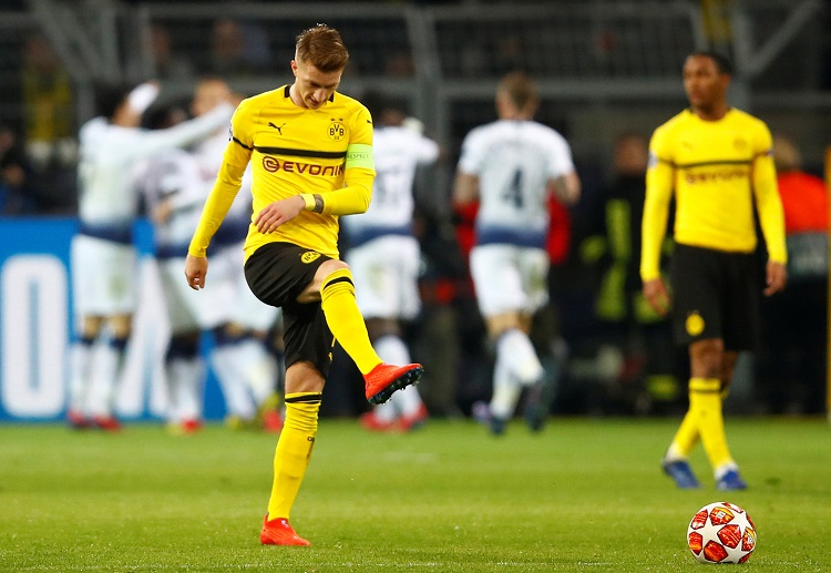 Borussia Dortmund forward Marco Reus reacts after conceding with Harry Kane’s away goal