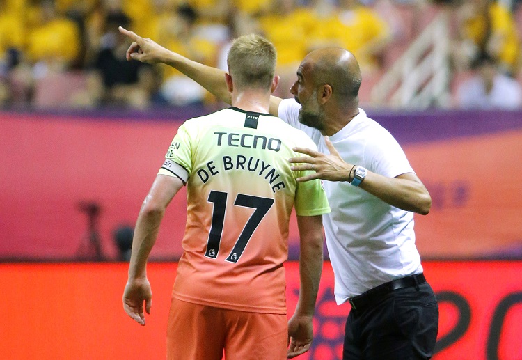 Kevin De Bruyne receives instructions from manager Pep Guardiola during their recent match in China