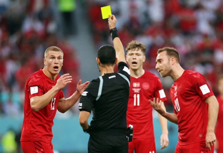 World Cup 2022: Rasmus Kristensen is shown the yellow card for a bad foul