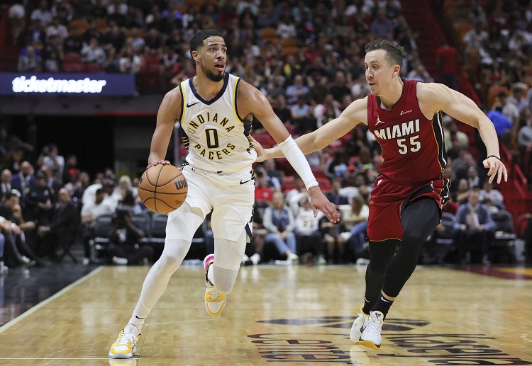 Pacers' Tyrese Haliburton drives to the basket against Heat's Duncan Robinson in their NBA matchup